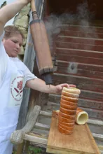 Taking off the cake from the baking spit — image 1