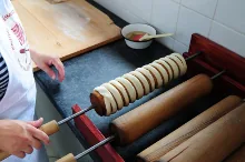 Wrapping the spun dough strip around the spit — image 3