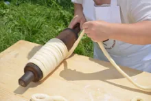 Wrapping the spun dough strip around the spit — image 4