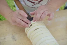 Wrapping the spun dough strip around the spit — image 5