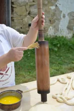 Brushing the baking spit with butter — image 1