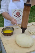 Brushing the baking spit with butter — image 2